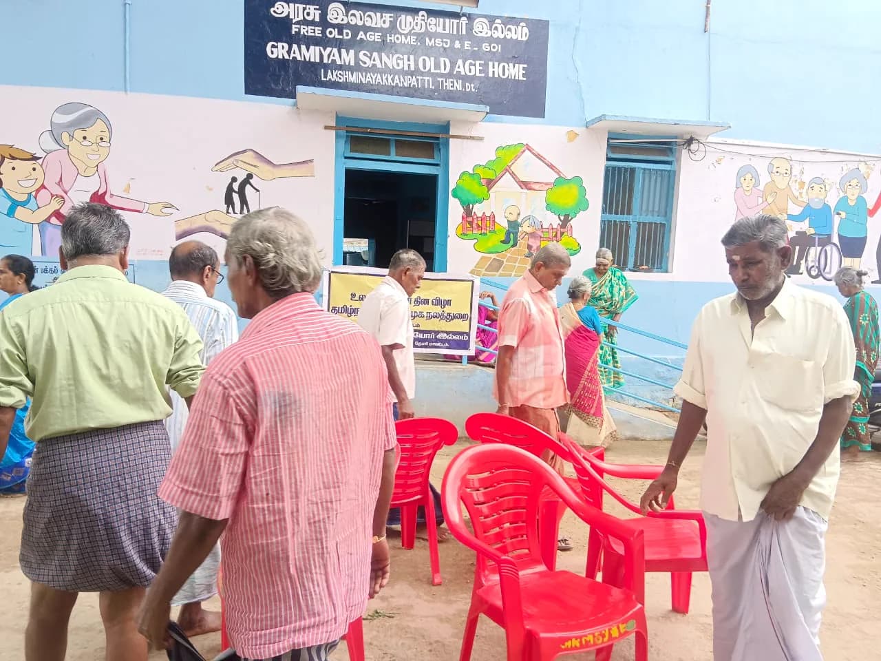 Gramiyam Sangh residents gathered outside the home